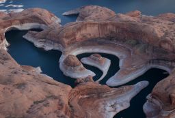 Not only is Lake Powell's water level plummeting because of drought, its total capacity is shrinking, too